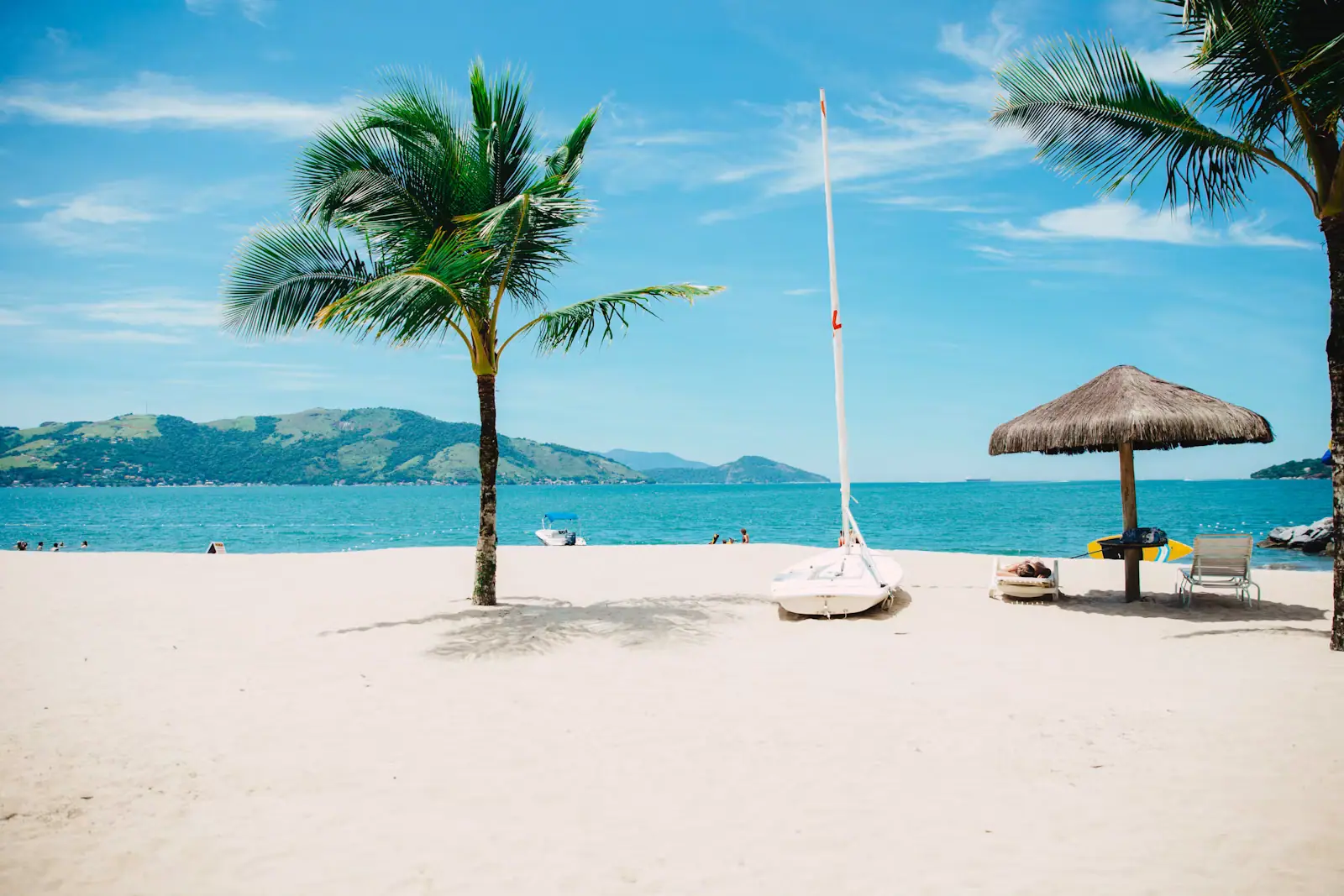 Loungers and palapas on a calm leeward beach at an all-inclusive beach club