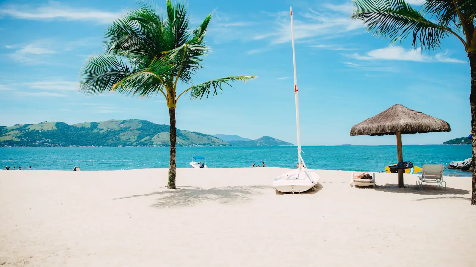 Loungers and palapas on a calm leeward beach at an all-inclusive beach club